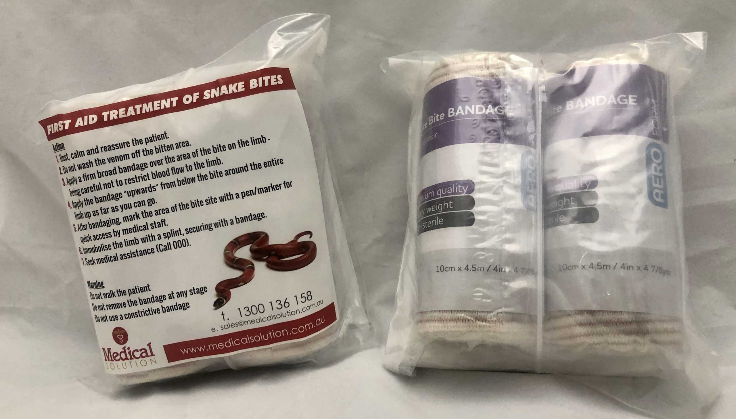 Snake bite first aid kit for sports, includes bandages and supplies for snake bite treatment in athletic settings.